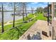 Lake view from patio showing outdoor seating, lush lawn, lake access and nearby docks on a bright sunny day at 13797 E Southshore Dr, Fishers, IN 46037