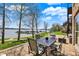 Covered patio featuring outdoor seating, lake view and access to lush lawn on a bright sunny day at 13797 E Southshore Dr, Fishers, IN 46037