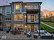 A brick patio with modern seating, perfect for outdoor entertainment, and two story deck, adds to the charm at 13797 E Southshore Dr, Fishers, IN 46037