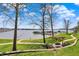 View of Geist Reservoir showing piers, lawn, and outdoor seating area with pergola at 13797 E Southshore Dr, Fishers, IN 46037
