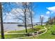 View of Geist Reservoir showing piers, lawn, and outdoor seating area with pergola at 13797 E Southshore Dr, Fishers, IN 46037