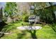 Large backyard with a quaint shed, fire pit area, and well-maintained lawn at 1410 E 75Th St, Indianapolis, IN 46240