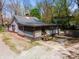 Charming home with a screened porch, complemented by mature trees and a welcoming gravel driveway at 1410 E 75Th St, Indianapolis, IN 46240