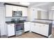 Modern kitchen with white cabinets, stainless steel appliances, and dark countertops for a sleek and functional design at 1410 E 75Th St, Indianapolis, IN 46240