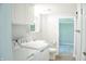 Functional laundry area with white washer and dryer, sink, toilet and adjacent bedroom, providing practicality and convenience at 1410 E 75Th St, Indianapolis, IN 46240