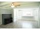 Open living room featuring a cozy fireplace, beamed ceilings, and abundant natural light, creating a welcoming atmosphere at 1410 E 75Th St, Indianapolis, IN 46240