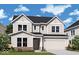 Charming two-story home features a two-car garage, brick accents, and manicured lawn at 14215 Coyote Ridge Dr, Noblesville, IN 46060