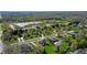 Aerial view of a neighborhood with lush green trees, homes, and a school campus at 14386 Salem E Dr, Carmel, IN 46033
