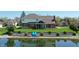 Aerial view of a brick home with a sunroom, backyard, and peaceful pond at 14386 Salem E Dr, Carmel, IN 46033