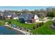 Aerial view of a home with lush greenery, a sunroom, and a serene lake at 14386 Salem E Dr, Carmel, IN 46033
