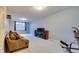 Finished basement with a comfortable sofa, large TV, and exercise equipment, ideal for recreation at 14386 Salem E Dr, Carmel, IN 46033