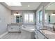 Bright bathroom with a tub, dual vanities, granite countertops, and a skylight provides natural light at 14386 Salem E Dr, Carmel, IN 46033