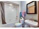 Bathroom featuring white tiles, a shower, bathtub, light gray walls, one sink, and a toilet at 14386 Salem E Dr, Carmel, IN 46033