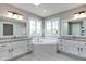 Bright bathroom features dual sinks, tile flooring and soaking tub with windows at 14386 Salem E Dr, Carmel, IN 46033