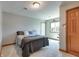 Bedroom with carpet, one bed, light gray walls, one window and a wood door at 14386 Salem E Dr, Carmel, IN 46033
