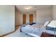 Neutral bedroom with plush carpet, a bed, and warm wood trim adding character at 14386 Salem E Dr, Carmel, IN 46033