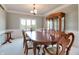 Formal dining room with elegant wood furniture, a large window, and crown molding for a refined touch at 14386 Salem E Dr, Carmel, IN 46033