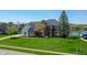 Beautiful brick home featuring a large front lawn, mature landscaping and views of the lake at 14386 Salem E Dr, Carmel, IN 46033