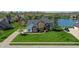 Beautiful brick home featuring a large front lawn, mature landscaping and views of the lake at 14386 Salem E Dr, Carmel, IN 46033