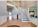 Spacious foyer with hardwood flooring, white wainscoting and a staircase leading to the second floor at 14386 Salem E Dr, Carmel, IN 46033