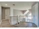 Upstairs hallway with hardwood floors, a modern chandelier, and white railing leading to the bedrooms at 14386 Salem E Dr, Carmel, IN 46033
