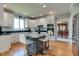Bright kitchen features white cabinetry, stainless appliances, subway tile backsplash and island with barstool seating at 14386 Salem E Dr, Carmel, IN 46033