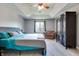 Main bedroom features a tray ceiling, hardwood floors, a large wardrobe, and ample natural light at 14386 Salem E Dr, Carmel, IN 46033