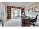 Inviting home office features custom built-in bookshelves and a large window with a pleasant neighborhood view at 14386 Salem E Dr, Carmel, IN 46033