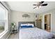 Bright bedroom with a ceiling fan, a calming color scheme, and a large window at 14429 Banister Dr, Noblesville, IN 46060