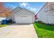 Attached two-car garage with concrete driveway and adjacent lawn at 14429 Banister Dr, Noblesville, IN 46060