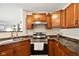 Updated kitchen with wood cabinets, granite countertops, and stainless steel appliances at 14429 Banister Dr, Noblesville, IN 46060