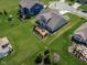 Aerial view of a home with a large backyard, concrete patio, fire pit, and lush landscaping at 15142 Blue Ribbon Blvd, Fishers, IN 46040