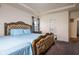 Spacious bedroom featuring carpet floors, tray ceilings, and a large bed frame at 15142 Blue Ribbon Blvd, Fishers, IN 46040