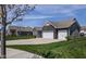 Charming home featuring an attached two car garage, a basketball hoop, and manicured landscaping at 15142 Blue Ribbon Blvd, Fishers, IN 46040