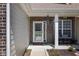 Inviting front porch featuring a seating area, brick accents, and a decorative door, offering a warm welcome at 15142 Blue Ribbon Blvd, Fishers, IN 46040