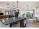 Open kitchen with granite countertops, a breakfast bar, and modern finishes, creating a functional and stylish space at 15142 Blue Ribbon Blvd, Fishers, IN 46040