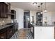 Spacious kitchen featuring dark cabinetry, stainless steel appliances, and a center island, perfect for culinary enthusiasts at 15142 Blue Ribbon Blvd, Fishers, IN 46040