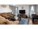 Relaxing living room featuring a comfortable sofa, modern entertainment center, and plenty of natural light at 15142 Blue Ribbon Blvd, Fishers, IN 46040