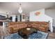 Spacious living room featuring a large sectional sofa, chandelier lighting, and hardwood flooring at 15142 Blue Ribbon Blvd, Fishers, IN 46040