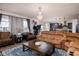 Open-concept living room featuring hardwood floors, multiple sofas and chairs, and ample natural light at 15142 Blue Ribbon Blvd, Fishers, IN 46040