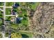 Birds eye view of residential home with a backyard, trees, lawn, and a nearby pond at 168 Yorkshire W Blvd, Cumberland, IN 46229