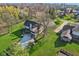 Aerial view showcasing the backyard with a deck, screened in porch, and lush green lawn at 168 Yorkshire W Blvd, Cumberland, IN 46229