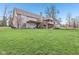 Expansive backyard with lush green lawn, mature trees, and a spacious multi-level deck at 168 Yorkshire W Blvd, Cumberland, IN 46229