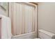 Cozy bathroom area featuring a shower tub combination with bright neutral-colored shower curtain at 168 Yorkshire W Blvd, Cumberland, IN 46229
