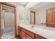 Traditional bathroom with wooden trim, neutral walls, and a spacious countertop at 168 Yorkshire W Blvd, Cumberland, IN 46229