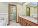 Bathroom featuring double sinks, bathtub, and a separate shower with a glass door at 168 Yorkshire W Blvd, Cumberland, IN 46229