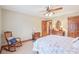Cozy bedroom with a rocking chair, wooden dresser, and a ceiling fan at 168 Yorkshire W Blvd, Cumberland, IN 46229