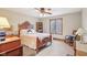 Inviting bedroom with a decorative bed, wooden accents, and natural light at 168 Yorkshire W Blvd, Cumberland, IN 46229
