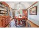 Traditional dining room features hardwood floors, elegant furnishings, and custom window treatments at 168 Yorkshire W Blvd, Cumberland, IN 46229