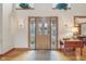 Inviting entryway with wood floors, a decorative door with sidelights, and a patterned rug at 168 Yorkshire W Blvd, Cumberland, IN 46229